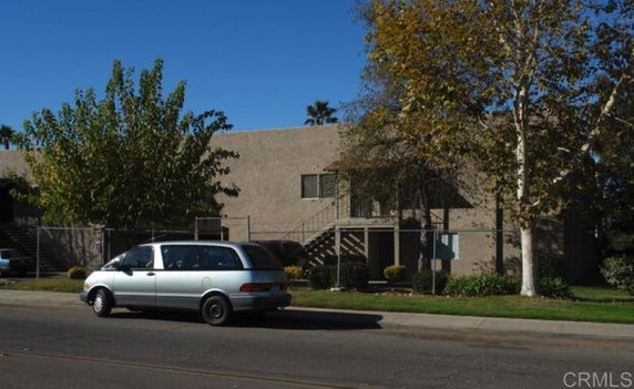 Front view of a two-story building with a staircase leading to the upper floor.
