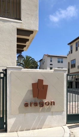Front view of a residential building entrance with a sign reading 'aragon'.