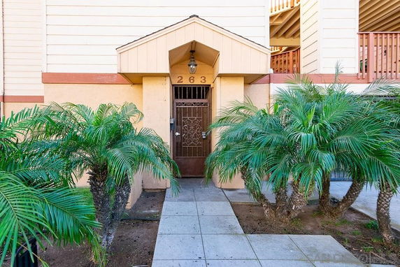 Front view of a building entrance with a metal gate and small awning.