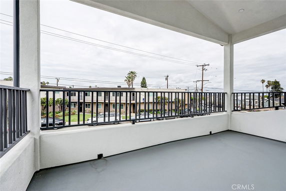 View of surrounding areas seen from the building balcony with railing.