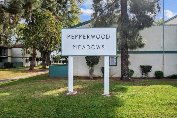 Front view of a building with a sign for Pepperwood Meadows.