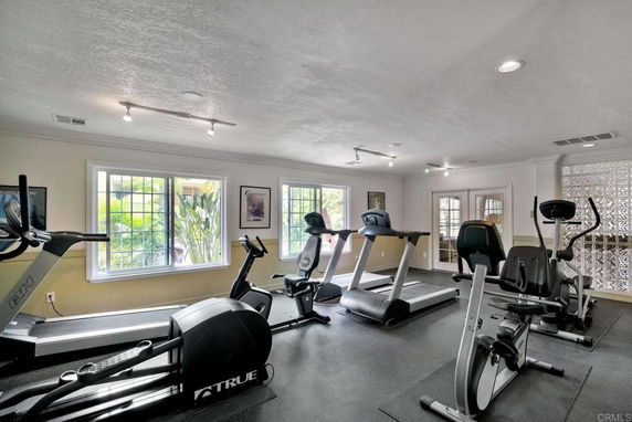 Indoor gym with exercise equipment like treadmills and bikes.
