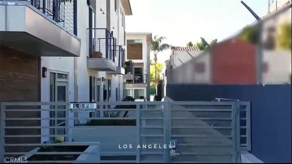 Front view of a multi-story apartment building with balconies.
