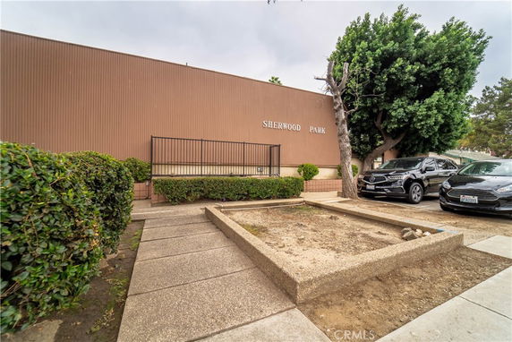 Front view of a building with brown walls and the name 'Sherwood Park' on it.