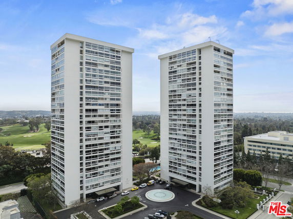 Front view of two high-rise residential towers.
