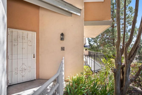 Entrance view of a building with a side door and railing.