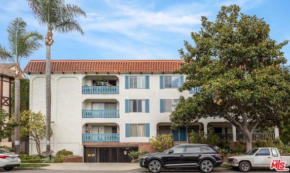 Front view of a multi-story residential building with balconies.