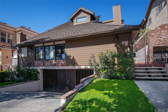 Front view of a house with a sloped roof and a garage.
