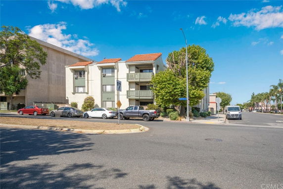 Front view of a multi-story residential building with balconies.