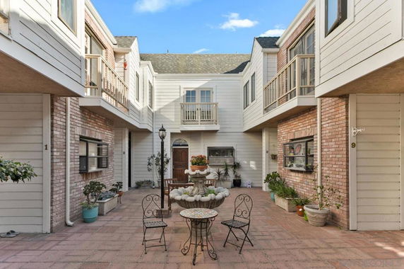 Front view of a residential building with courtyard.