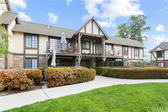 Front view of a two-story house with Tudor-style architecture featuring wooden frames and stone accents.