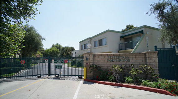 Front view of a gated residential building complex.