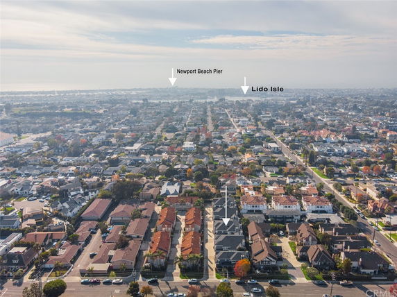 Wide-angle view of a residential area with multiple houses and streets extending towards the horizon.