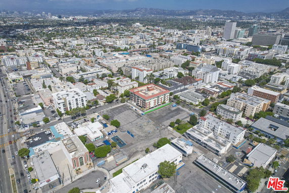 Panoramic aerial view of a city with numerous buildings and streets.
