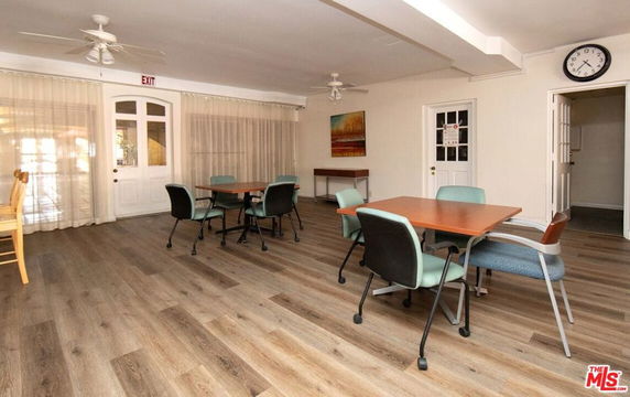 Room with tables and chairs, likely used for recreation or meetings.