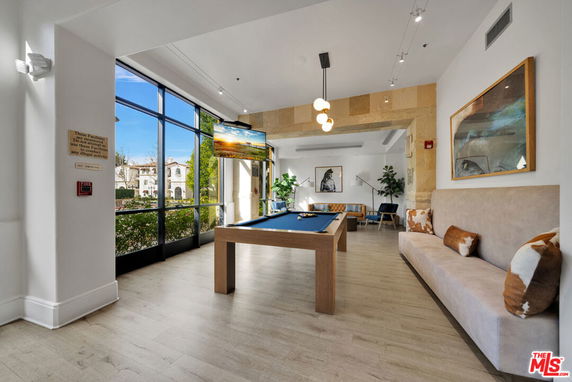 Indoor recreation area with a pool table and seating.