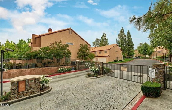 Front view of a residential building with a gated entrance.