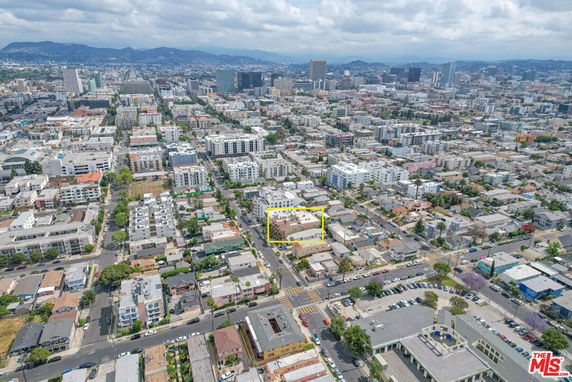 Aerial view of a cityscape with various buildings and streets.