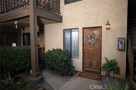 Front view of a two-story building with a decorated entrance door and window.