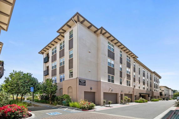 Front view of a multi-story apartment building with a modern design.