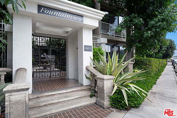 Front view of a building entrance with a gated entry and signage reading 'Fountainview'.