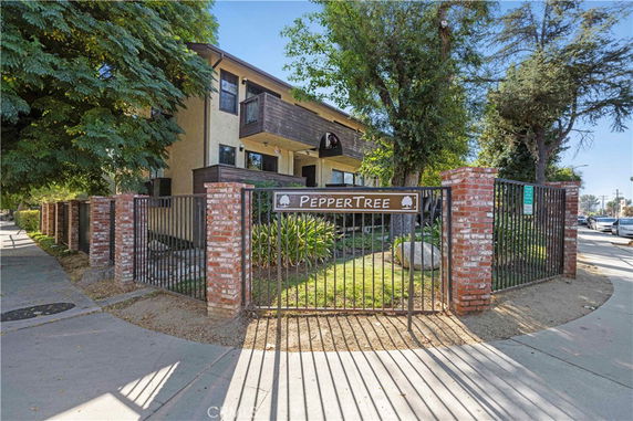 Front view of a two-story building with a gated entrance named 'PepperTree'.