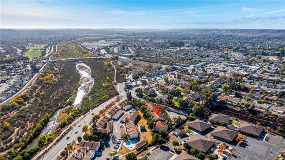 Aerial view of a suburban neighborhood with houses and natural landscapes.