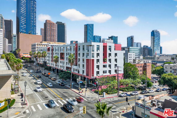 Front view of a modern multi-story apartment building in an urban setting.