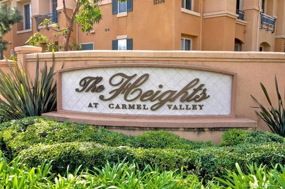 View of a building with a sign that reads 'The Heights at Carmel Valley'.