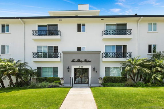 Front view of a multi-story residential building with balconies.