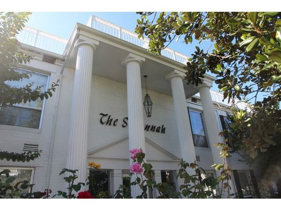 Front view of a building with tall columns and a sign reading 'The Savannah'.
