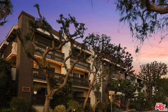 Front view of a multi-story apartment building with balconies.