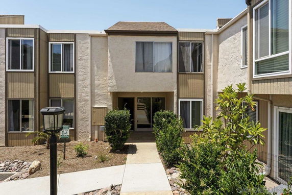 Front view of a two-story apartment building with multiple windows and a central entrance.