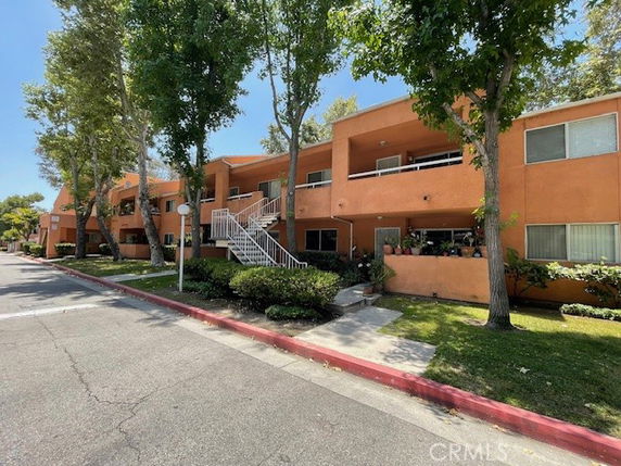 Front view of a two-story apartment building with exterior staircases.