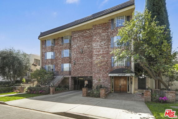 Front view of a multi-story brick building with a covered entrance