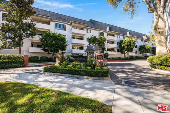 Front view of a multi-story residential building with balconies.
