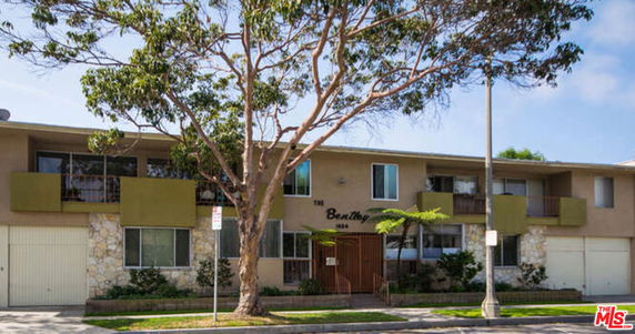Front view of a two-story building with balconies and a central entrance.