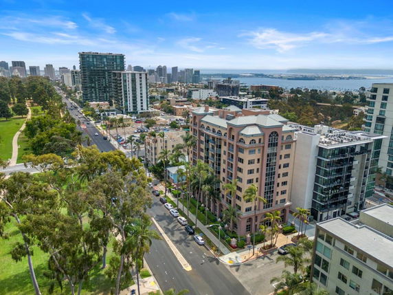 Panoramic view of a cityscape with multiple buildings and a park.