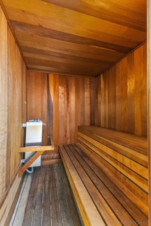 Wooden interior of a sauna room with benches.