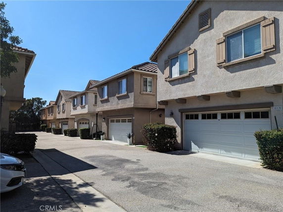Front view of townhouses with attached garages.