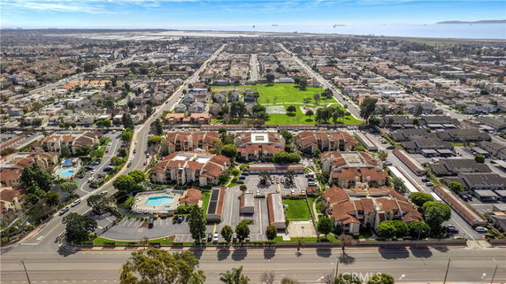 Aerial panoramic view of a residential area with multiple buildings and streets.