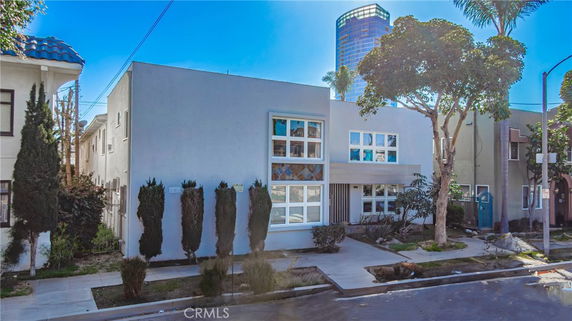 Front view of a modern two-story building with large windows and a flat roof.