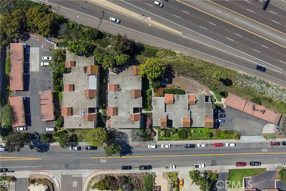 Aerial view of a residential complex near a highway.