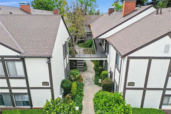 Front view of a connected two-story residential building with walkways.