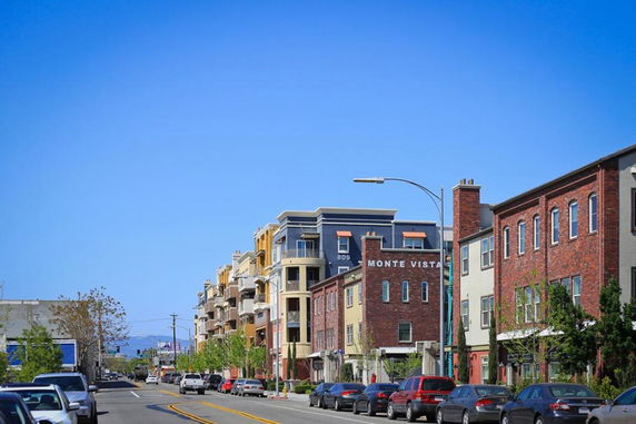 Front view of multi-story residential buildings on a street.
