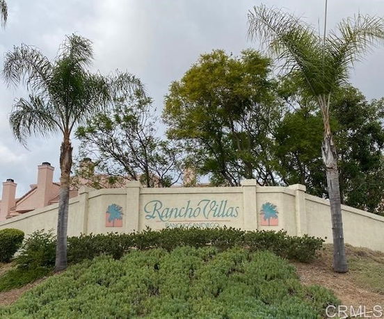 Entrance signage of Rancho Villas with a landscaped area.