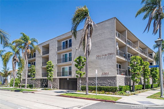 Front view of a multi-story residential building with balconies.