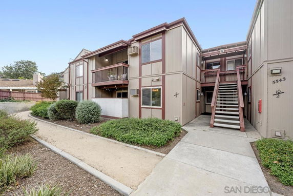 Front view of a two-story apartment building with exterior staircases.