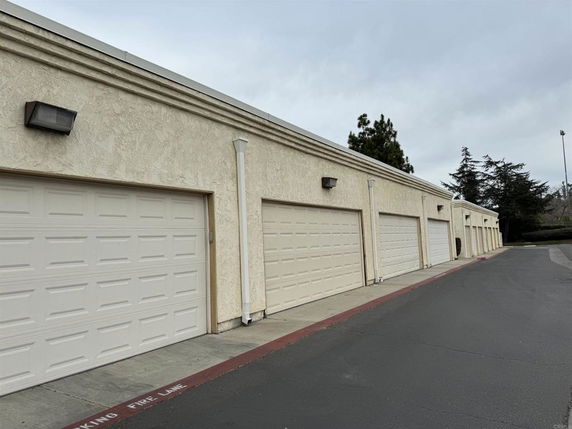Row of garage doors in an outdoor parking area.