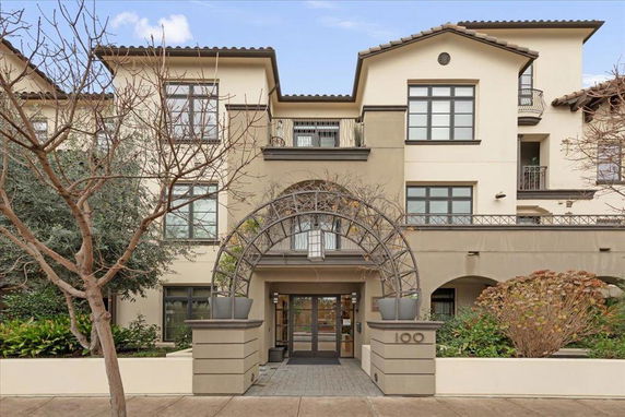 Front view of a two-story building with multiple windows and an arched entrance.